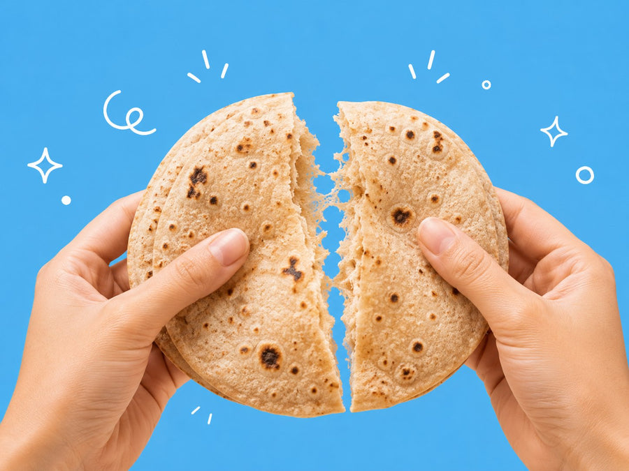 Hands breaking a chapati in half